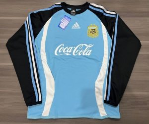 BUZO AFA CELESTE COCA COLA TALLES(M/L)